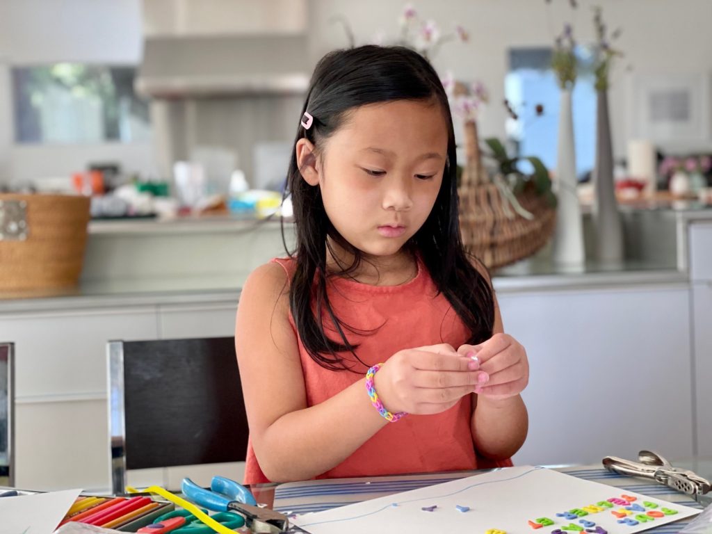 Child making an environmental poster. We'll study the environment at Camp Grandma.