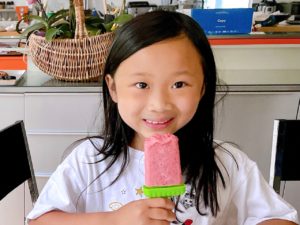 Child eating a paleta, Mexican frozen ice pop.