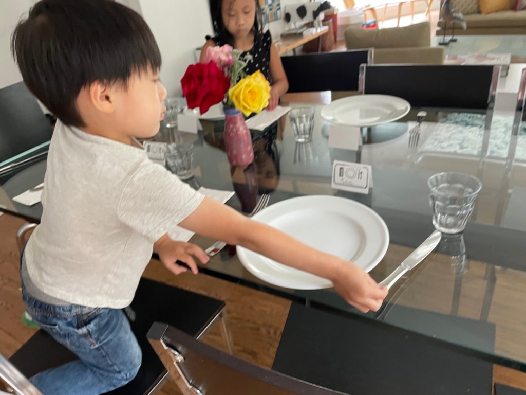 Children setting the table.  We'll learn to take responsibility for household chores at Camp Grandma.