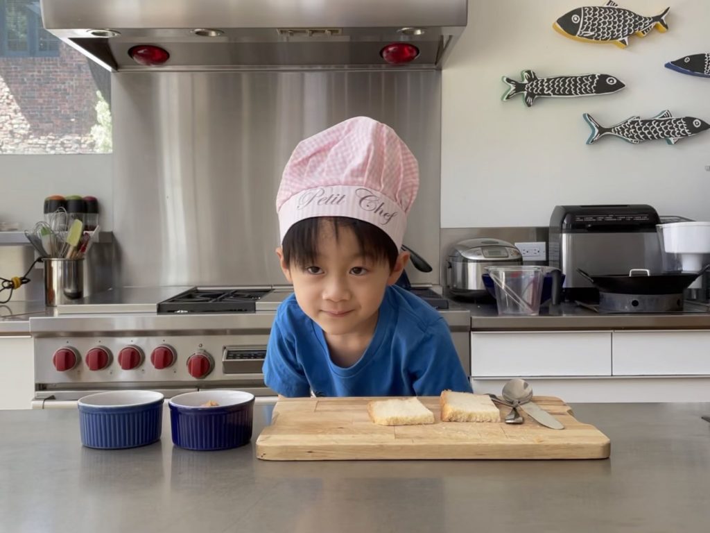 Child in chef's hat making peanut butter and jelly sandwiches.  We'll make our own lunch at Camp Grandma and do video demos.