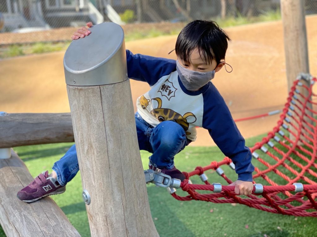 Child in the playground. Masks are required.
