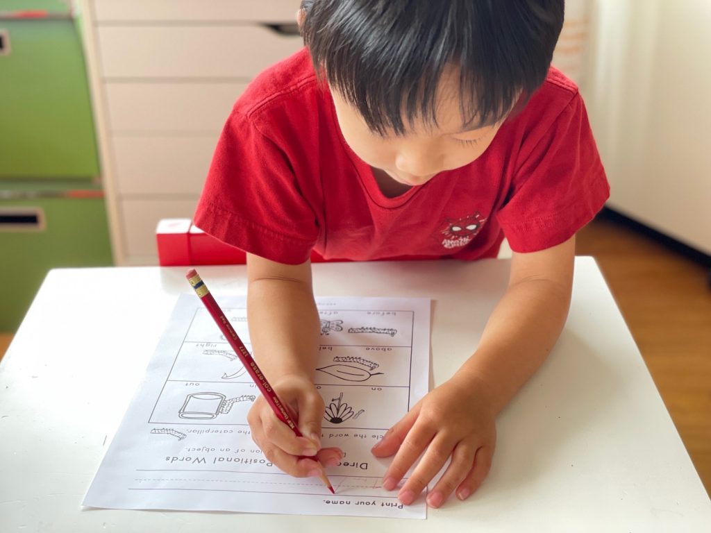 Child working on understanding directional and positional words to prep for kindergarten at Camp Grandma.