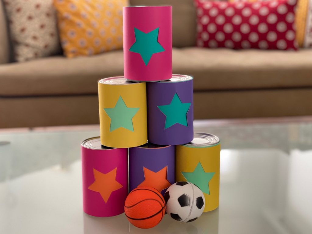 Carnival game is made with empty food cans decorate with cardstock.