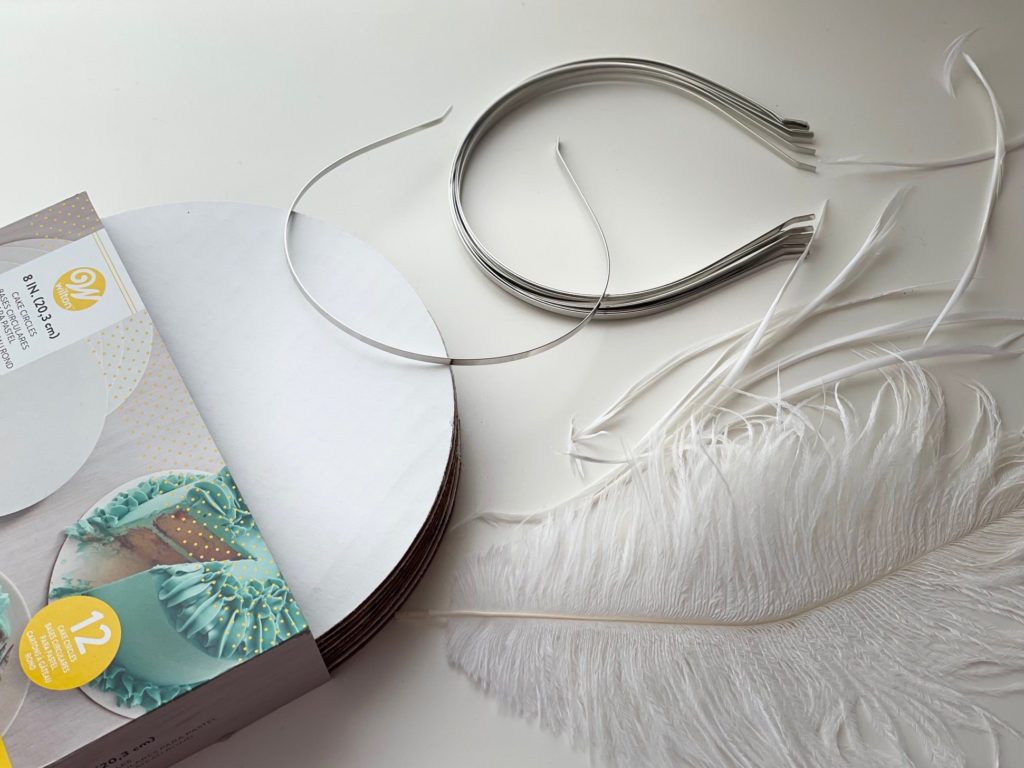 How to make fascinator: some materials you need: cake cardboard, headband, and feathers.