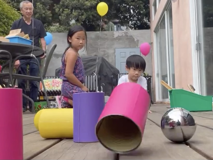 We played this game like bowling, rolling a heavy ball at the pyramid of cans.