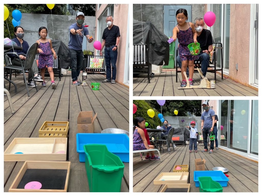 Everyone takes turn tossing bean bags into assorted vessels.