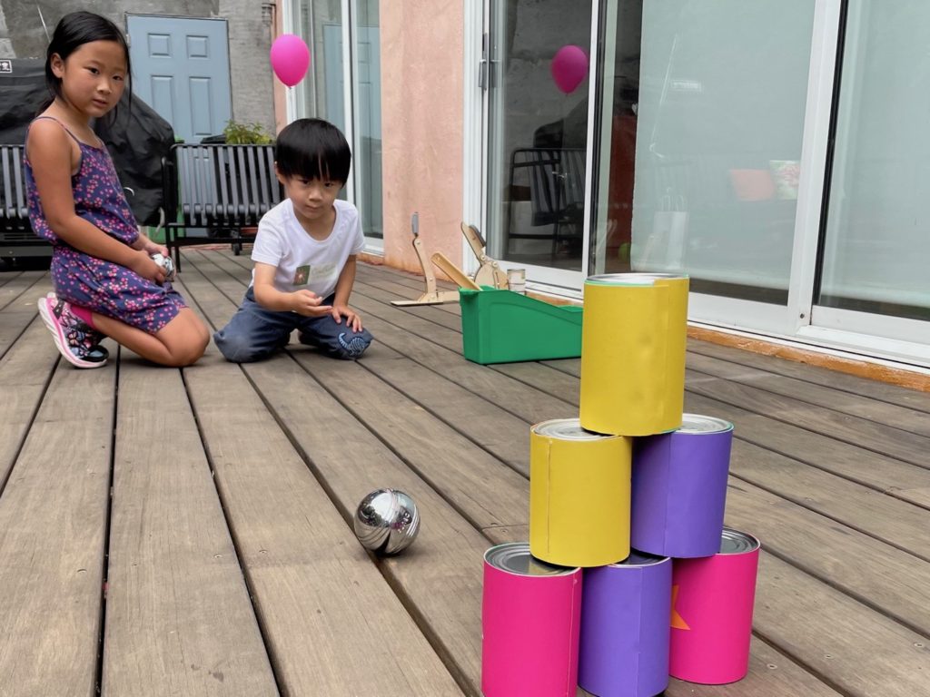 A carnival game made from empty food cans.