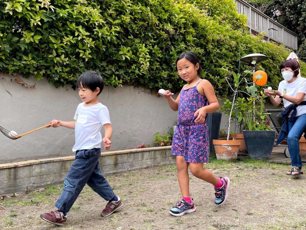 Egg race is more challenging and handicaps younger players when the adults use chopsticks instead of spoons.