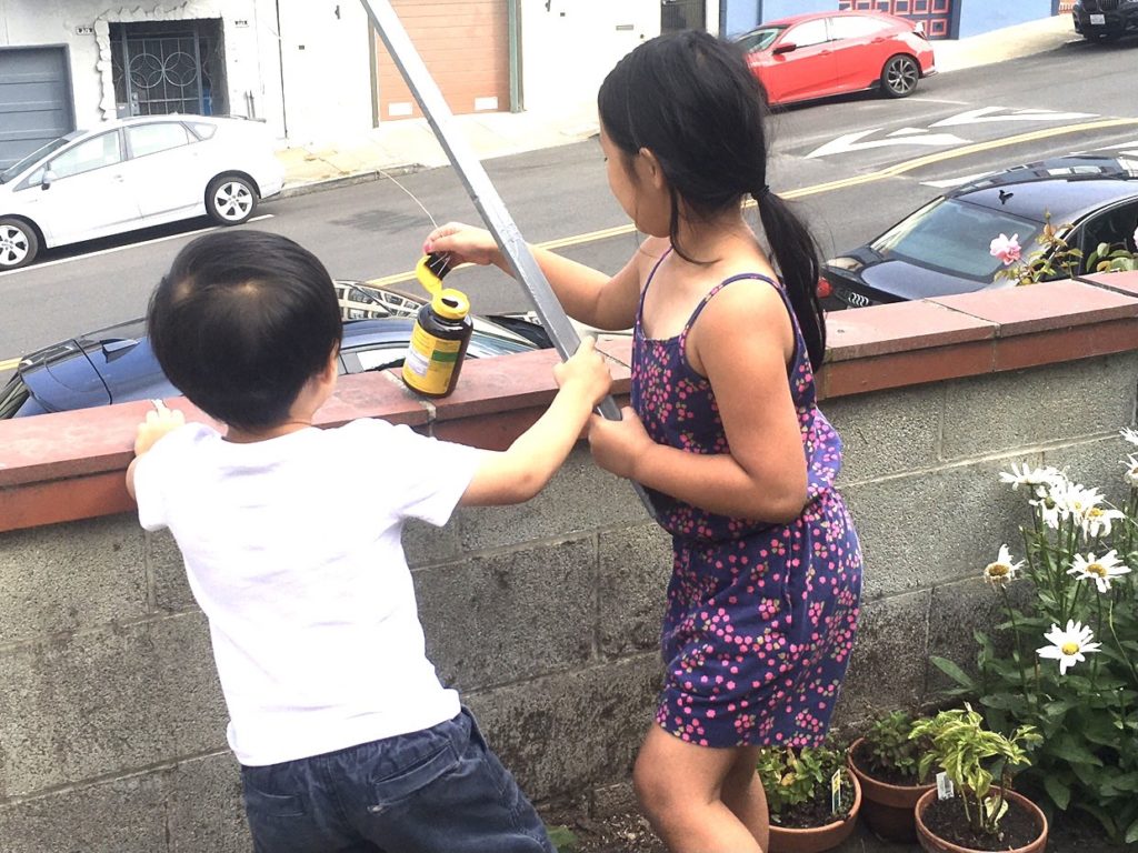 Kids catch a bottle of vitamin pills--some of the trash--instead of "fish."