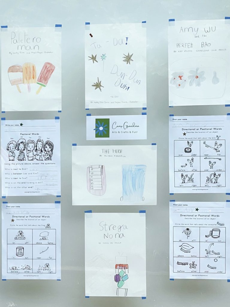 Illustrations of books read and  completed worksheets are displayed for parents to see at the Camp Grandma summer party.