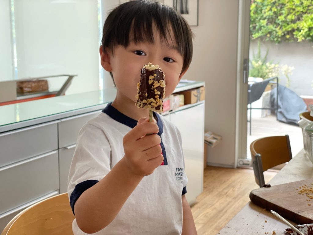 Time to try his own creation. Little N is ready to take a bite out of his banana pop.