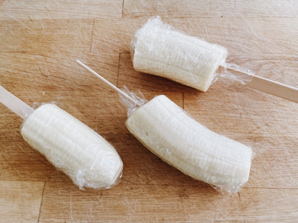 To make banana pops, cut bananas in thirds, insert a wooden stick in each, wrap in plastic wrap and freeze firm.