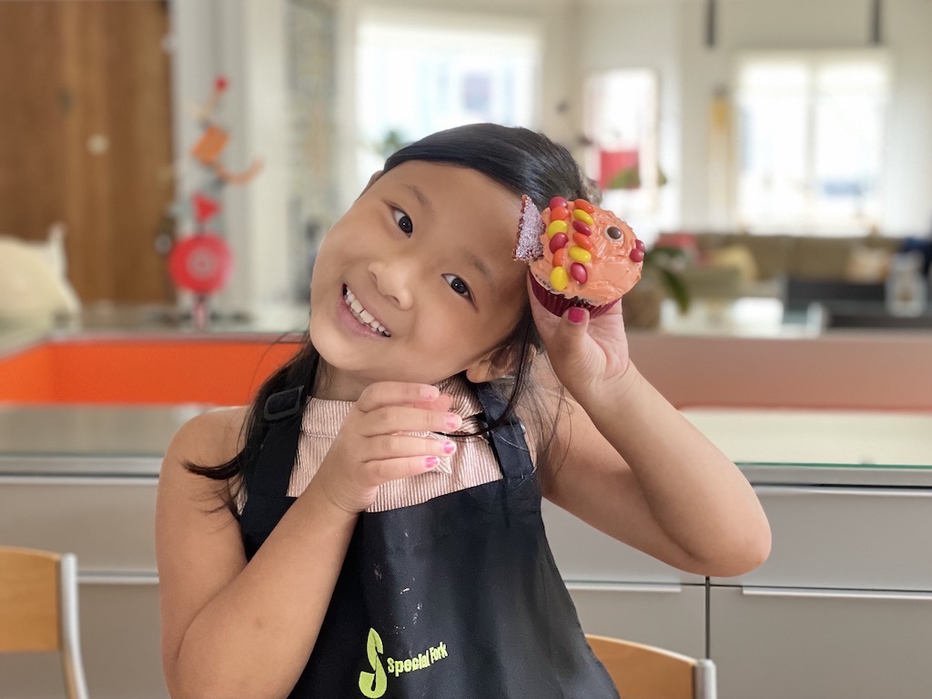 Miss T shows off the cupcake she made. These cute fish cupcakes are a great project for a child.