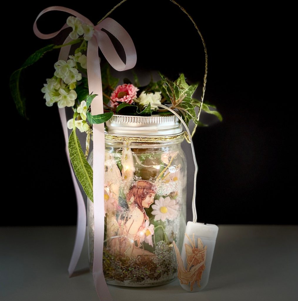 A child's delight: the completed fairy lantern: glitter, moss, LED fairy lights, leaves, flowers, ribbons--home for a beautiful fairy.