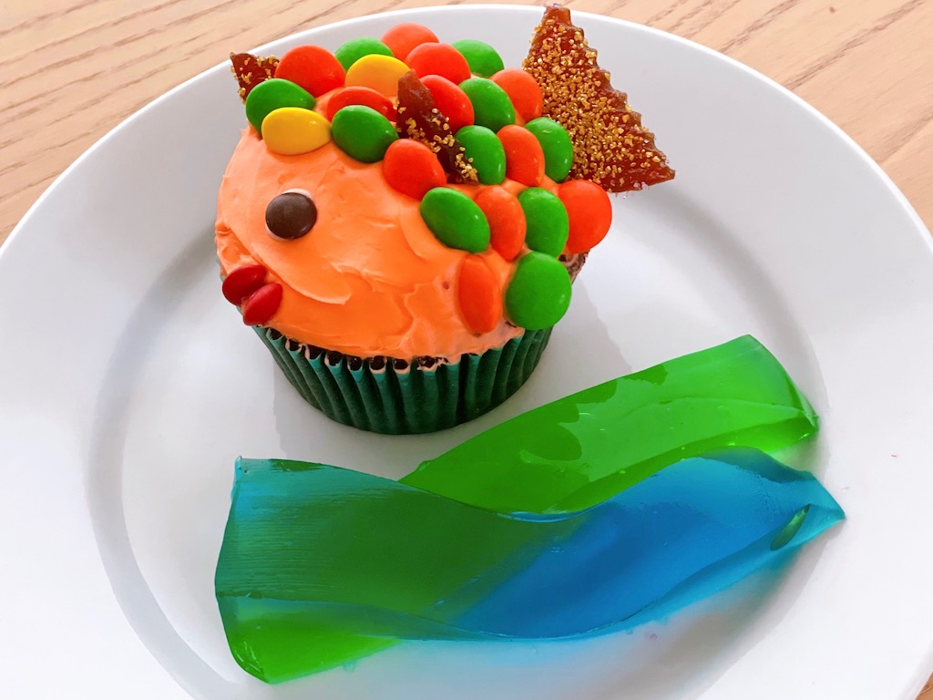 This cute fish is easy to make with regular and mini M&M's. A type of fruit rollup was used for fins and tail. The ocean is made from blue and green Jell-O fortified with gelatin to be stable at room temperature.