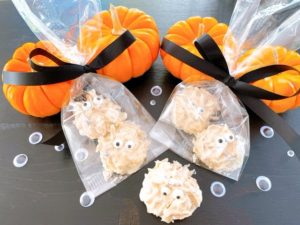 Ghostly Halloween treats are packaged in cellophane bags and tied with black bows.