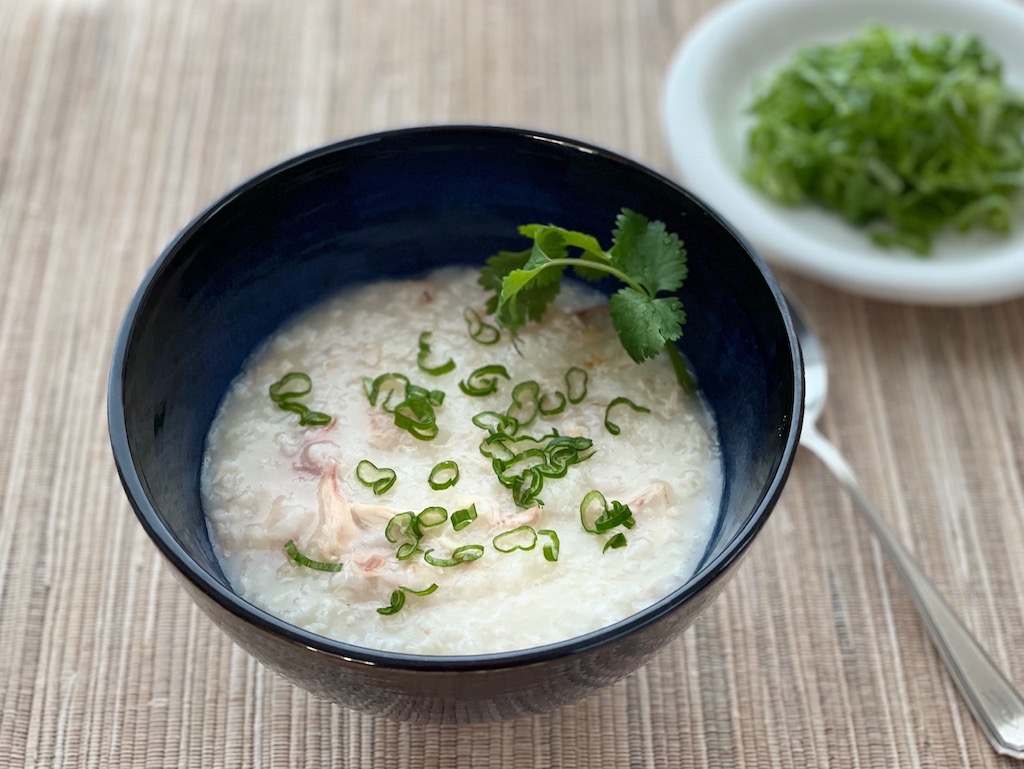Jook, Chinese rice porridge is made with turkey stock from a turkey carcass. Serve with green onion, cilantro, and lettuce.