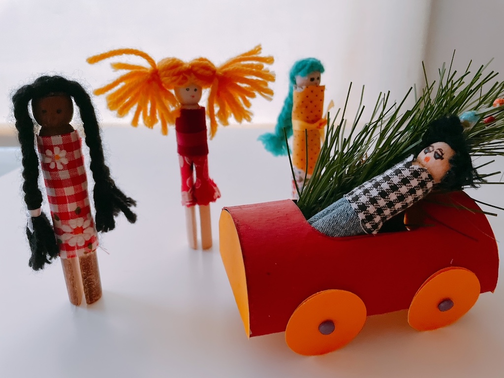 The cars were inspired by Little N, who used a shallow box as a car to bring home a Christmas tree for the clothespin family.
