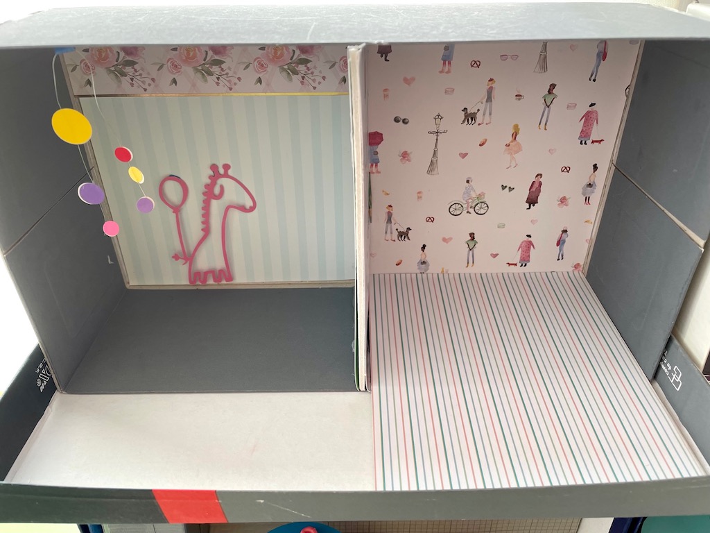 To ensure that the DIY dollhouse is collapsible after playing, extend inner walls just to the edge of the shoebox; make the floors removable.