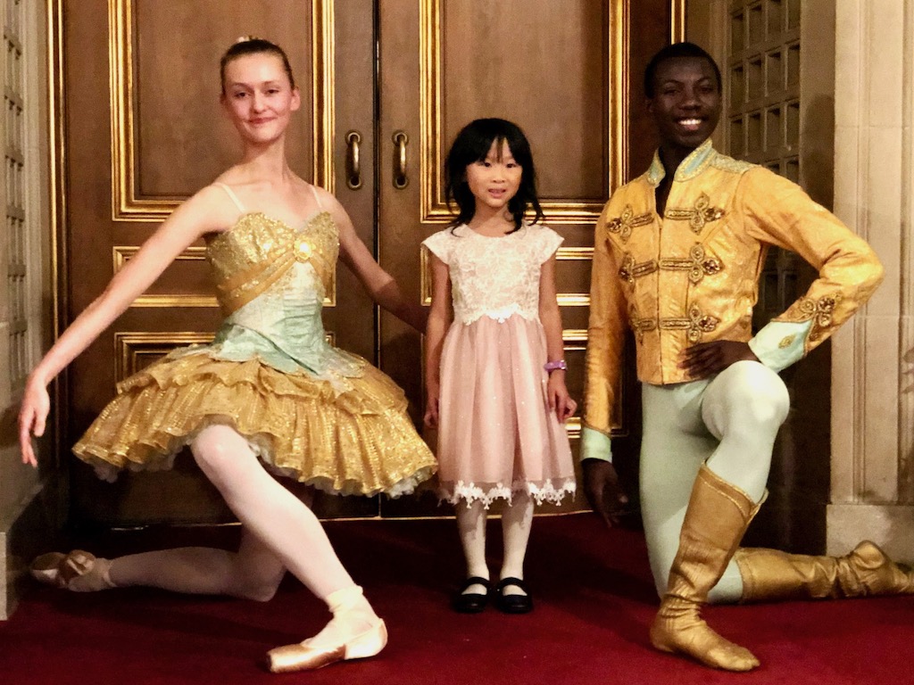 Nutcracker dancers with child before the performance.