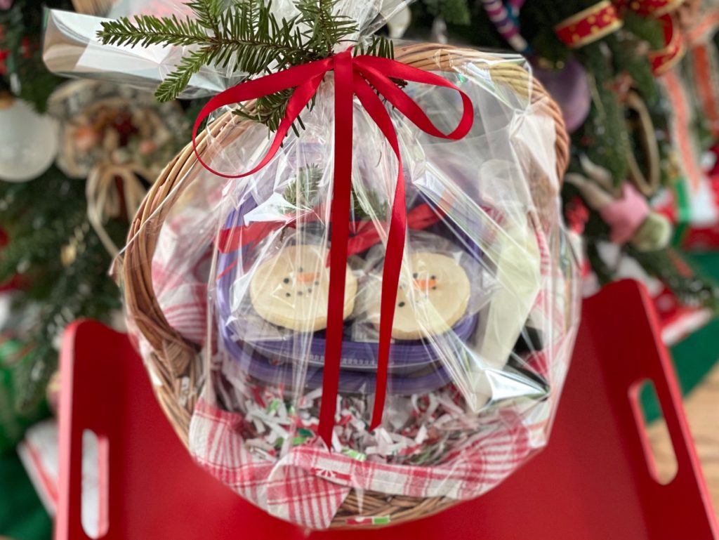 Basket of baked cookies, icings and sprinkles is wrapped in cellophane and tied with a red bow. They were sent to the grandkids since we couldn't get together for the annual Christmas cookie baking.