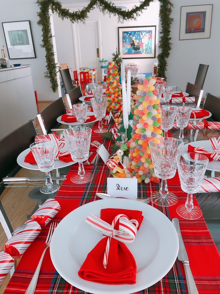 The table set with gumdrop trees, crystal stemware, and everyday china.