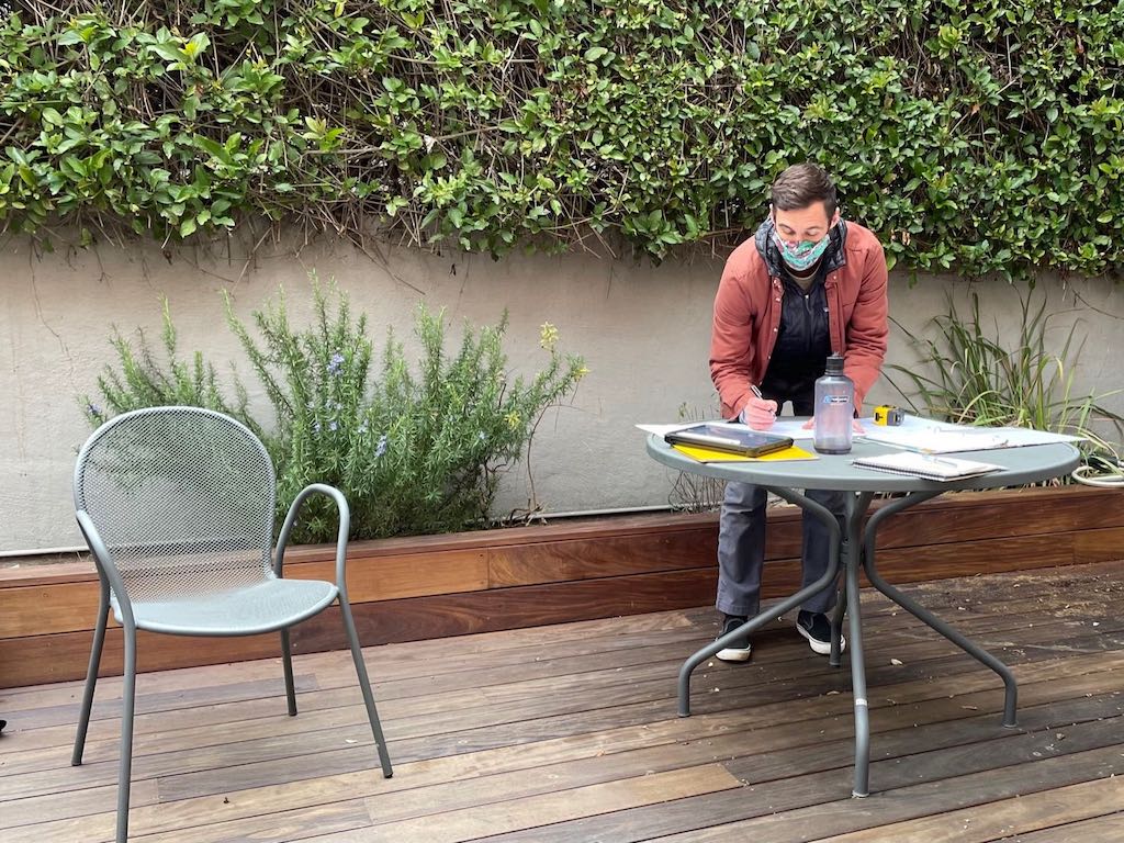 Joe Couture, VP Head of Design and Installation at Janet Moyer Landscaping, measuring the garden space.