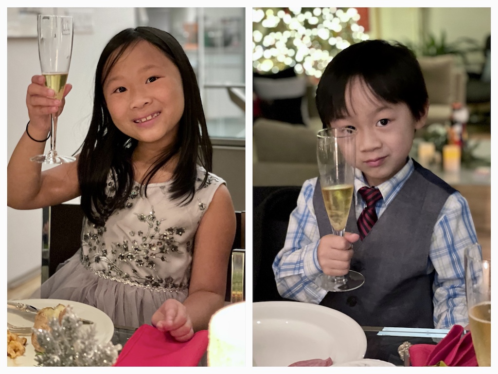 Kids, dressed up, toast the New Year with sparkling apple juice. They learn to be well-behaved diners at this special dinner with grandkids.