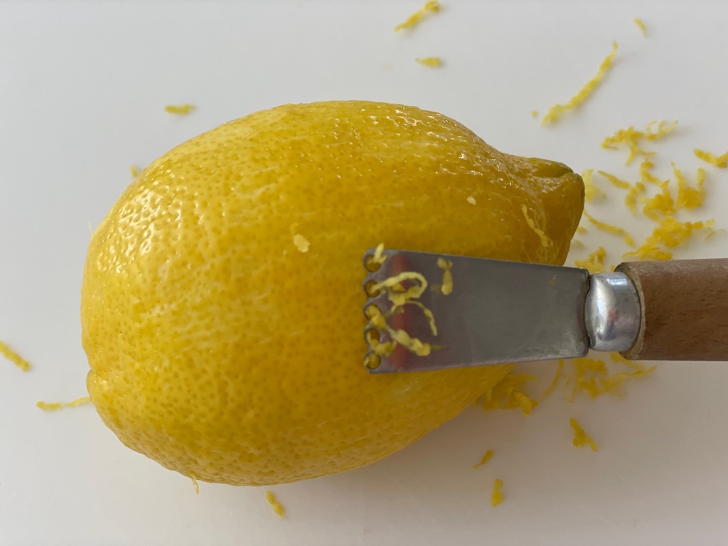 Even simpler to use is a citrus zester tool. It makes thicker shreds.