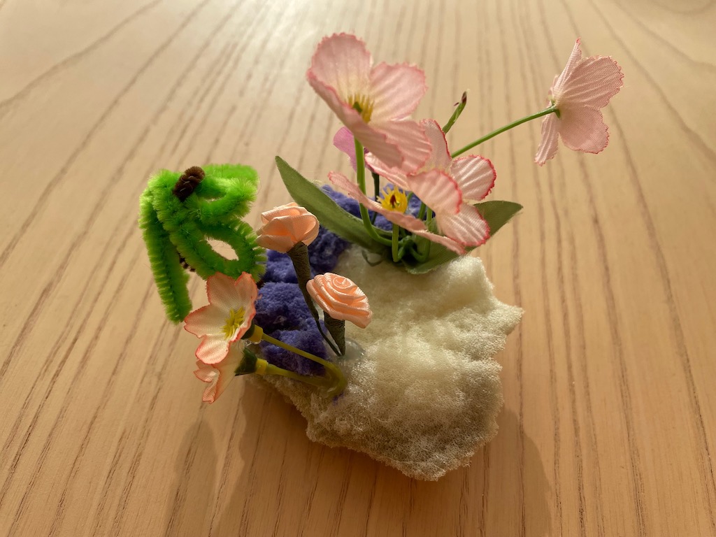 Flower arrangement made with the stuffing from a burst ball, is the the kind of result that happens in an environment that inspires imagination.