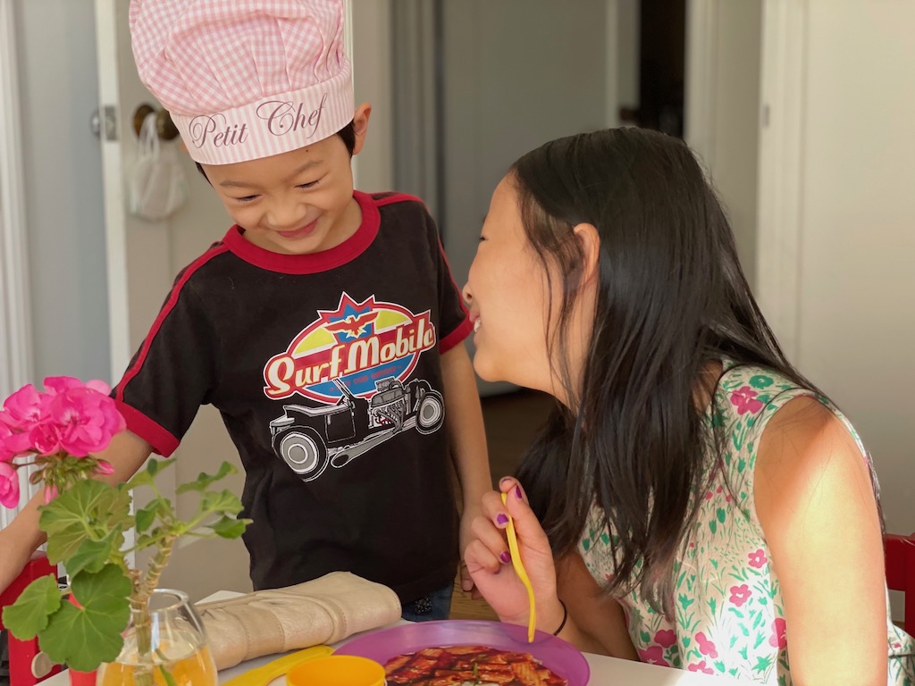 Children playing the restaurant game with magazine cut-out food.