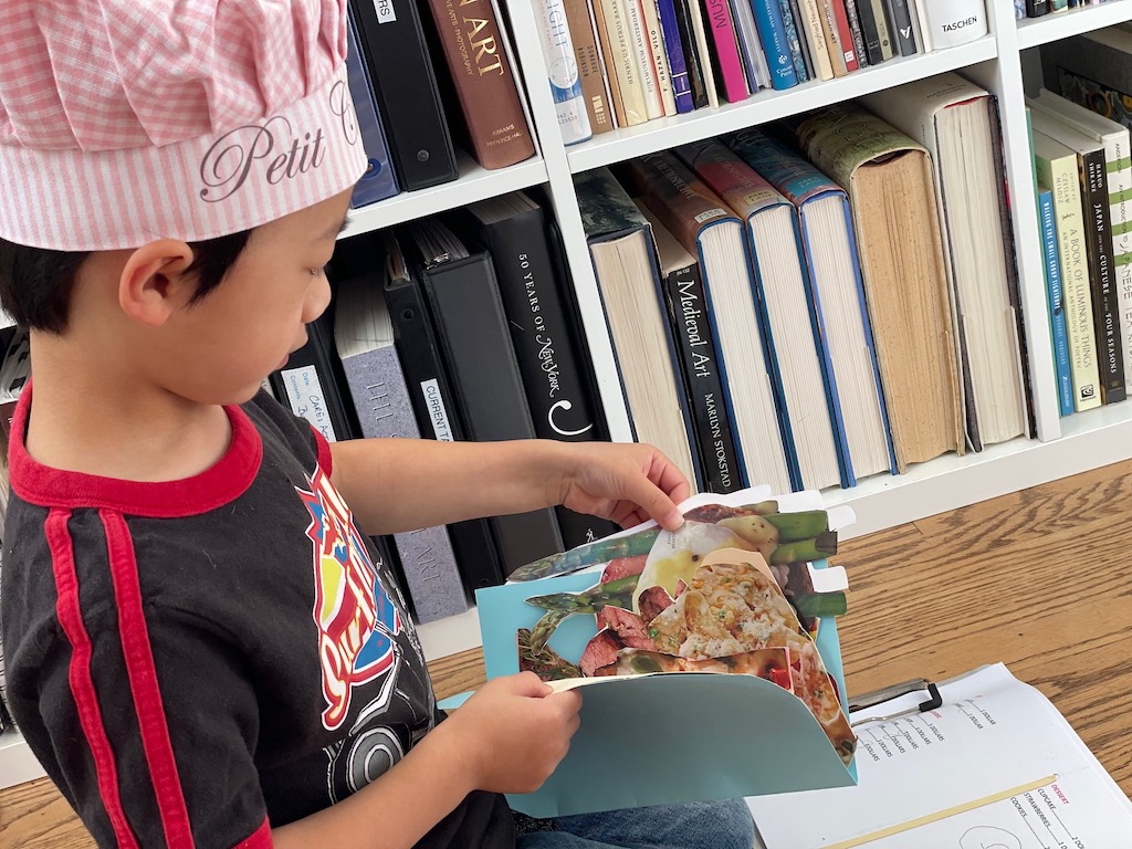 Child chef finding the right cut-out food to fill the order.