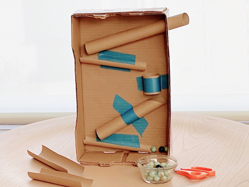 A successful marble run features cardboard tubes and halved cardboard tubes.