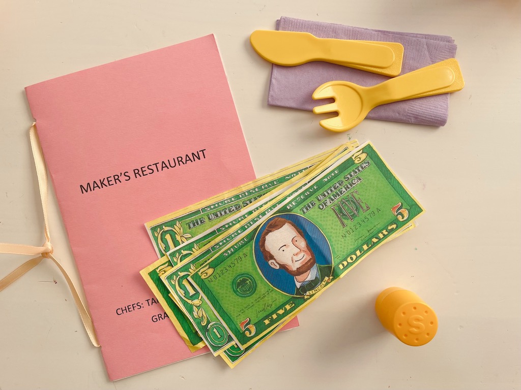 Menu and play money are needed to play the restaurant game.