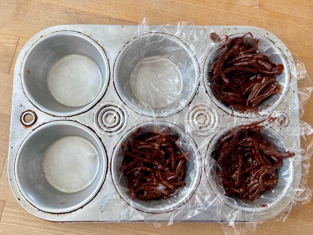 To make small nests, line muffin tin cups with plastic wrap; then add chocolate-coated chow mein mixture.