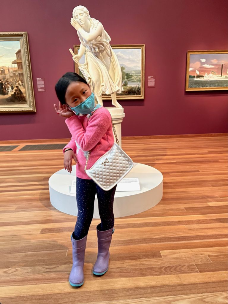 Blind Flower Girl of Pompei. De Young Museum, San Francisco. Child mimics the pose during her art museum trip.