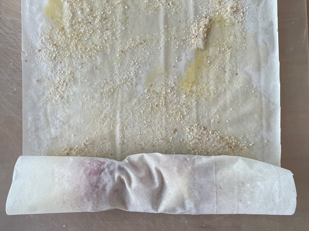 Step 2: Roll edge of phyllo sheet over berries.