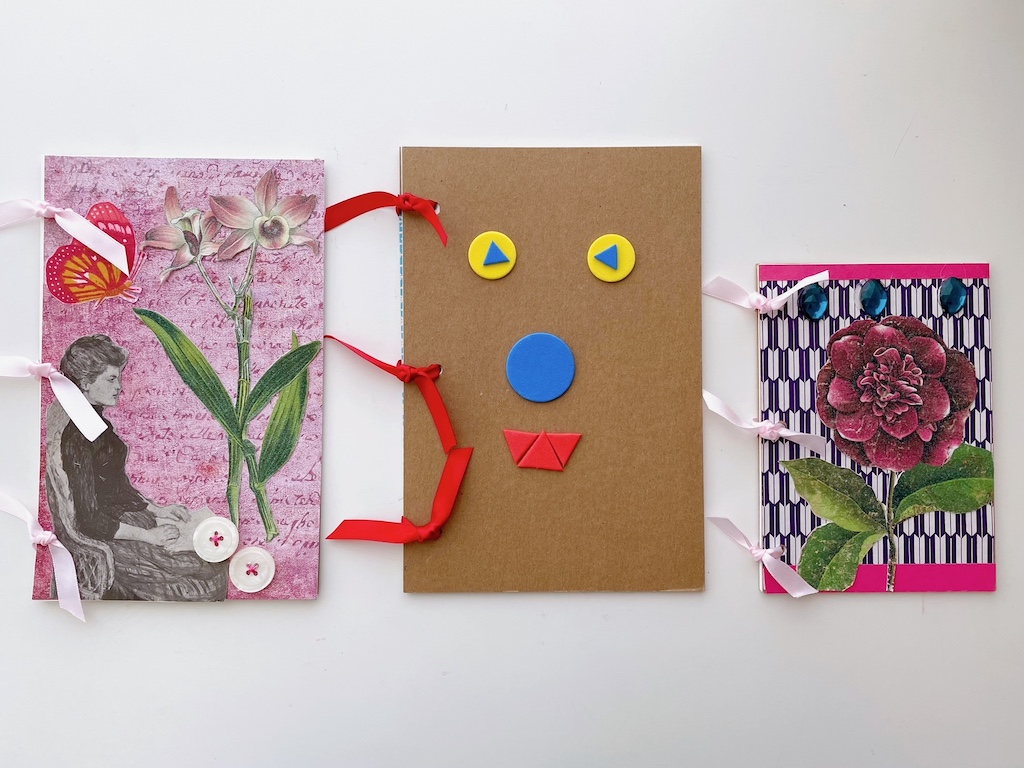 Finished notebooks are collages made with various kinds of paper, ribbons, buttons, and "jewels."