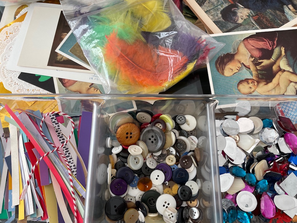 Set out art reproduction postcards, buttons, "jewels," and other decorative items for the collages.