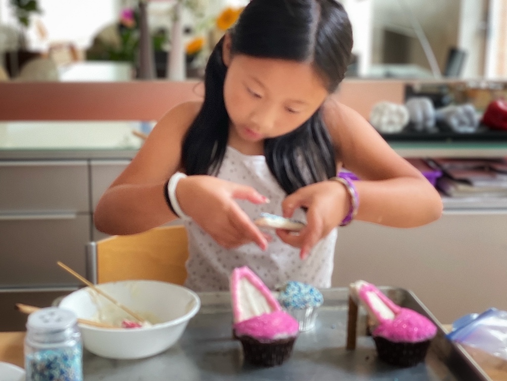 Placing the graham cracker sole on the cupcake to make the high heel shoe.