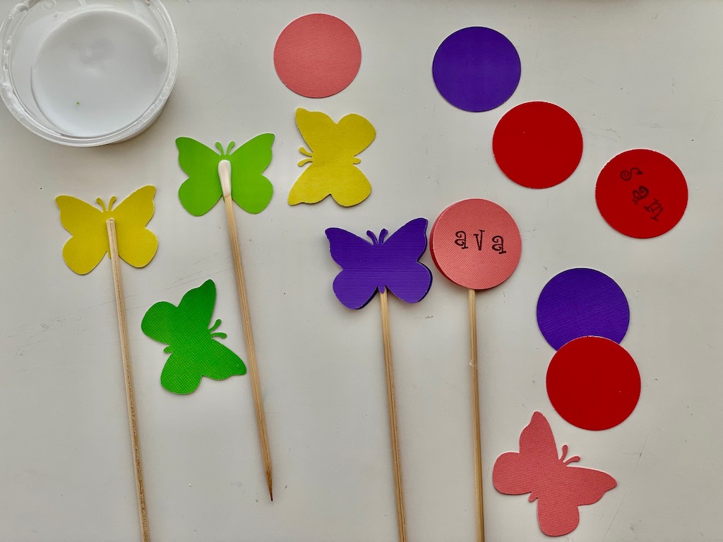 Glue butterflies or other cardstock decorations into skewers.