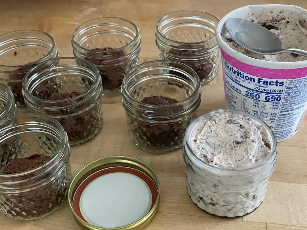 With one layer of brownies on the bottom of a mini mason jar, spoon ice cream to fill the jar.