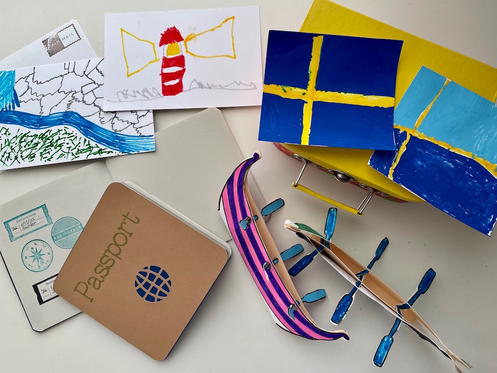 Souvenirs from the pretend trip: postcards, Viking ships, and Swedish flags; passport is stamped.