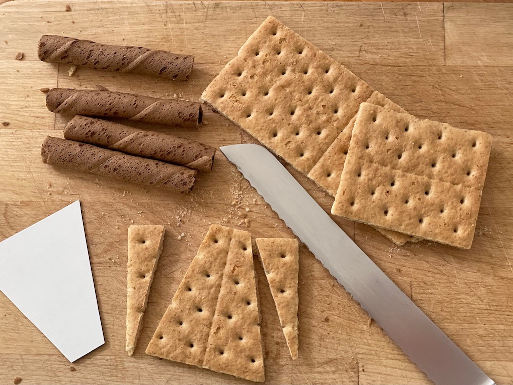 Cookie sticks are halved and graham crackers are cut to size to make high heel cupcakes.