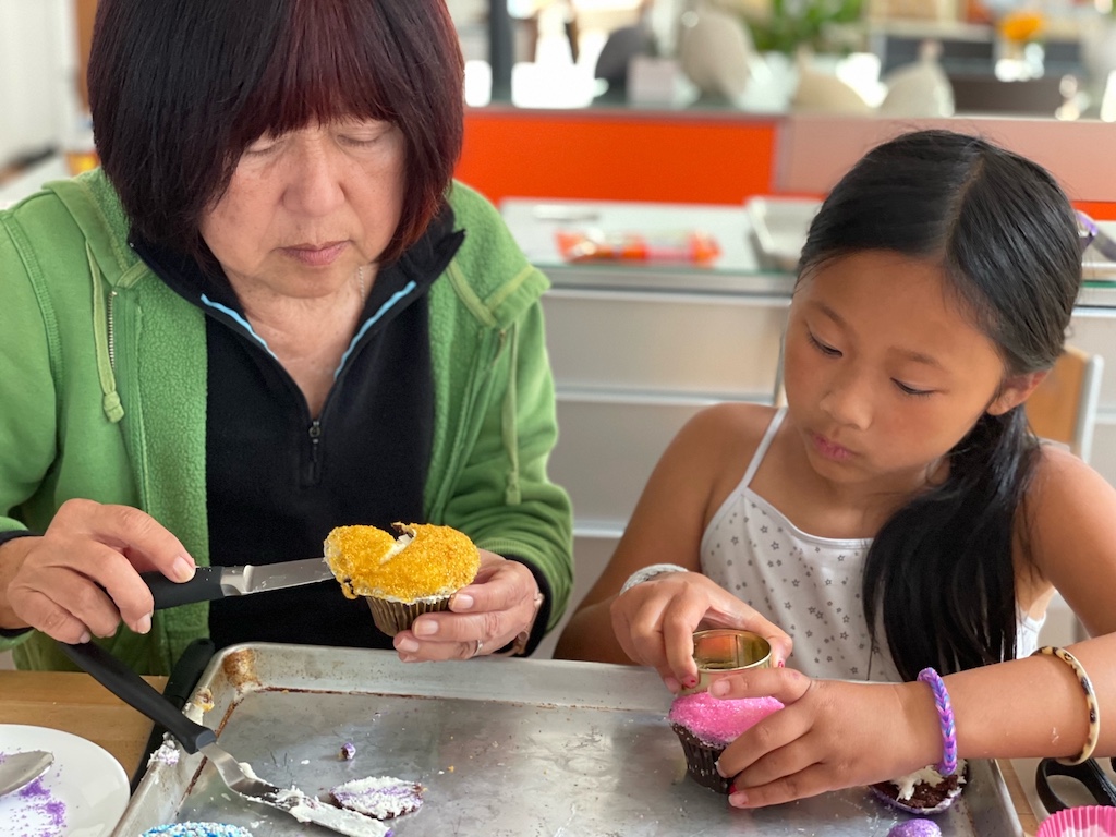 Grandma and granddaughter work together to make high heel cupcakes. Having adult guidance ensures a positive result to build confidence in a child.