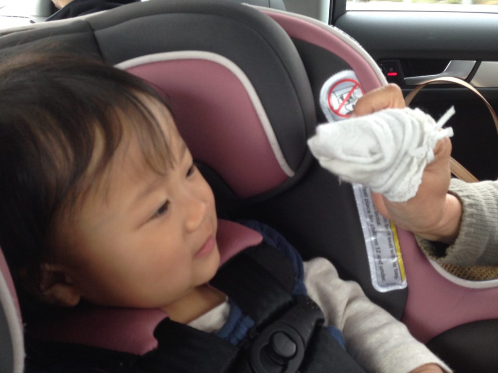 Sometimes, it takes imagination to play with grandkids. Entertain a child in the car with a puppet made by pulling a sock off her feet.