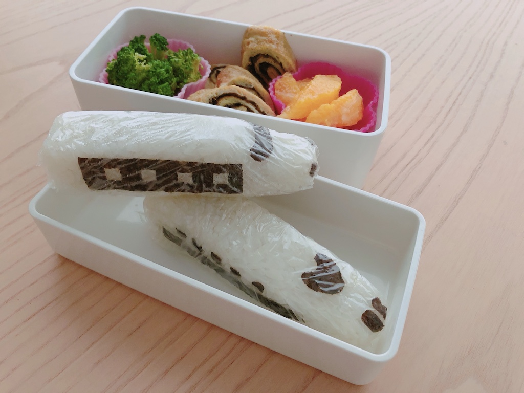 The bullet train onigiri is made from a mold with a plastic stencil to punch out the decals from a nori sheet.