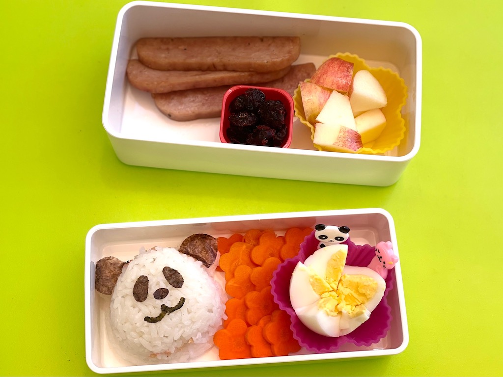 Miss T made this bento herself: panda onigiri, carrot flowers, egg flower, spam, apple chunks and dried cranberries.