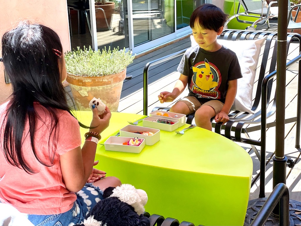 Kids eat their bento lunch on the deck. When you've made the best bento, you'll eagerly consume the whole thing.
