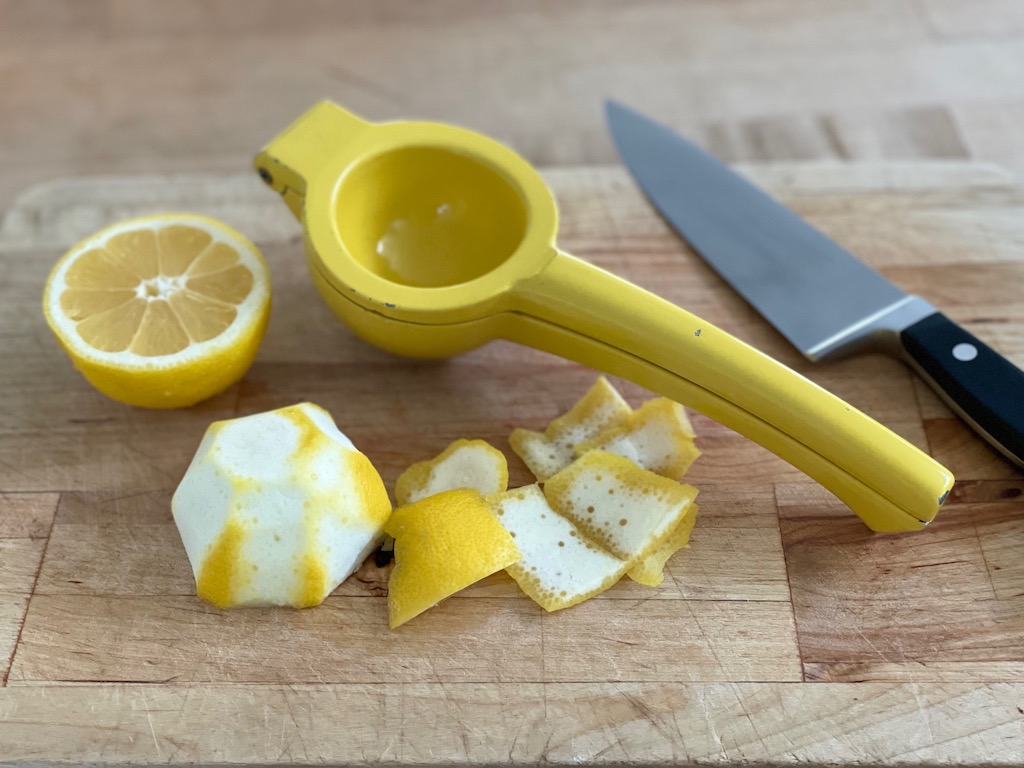 Cut rind away from lemon half before squeezing to extract the juice easily.